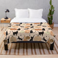 Plush throw blanket featuring a watercolor pattern of black cats and pumpkins for fall and Halloween
