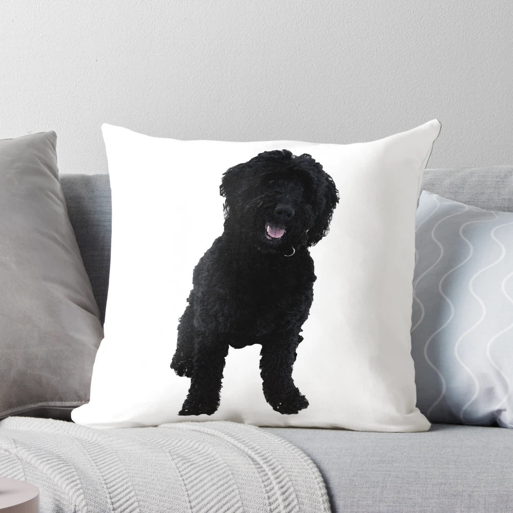A soft, plush pillow featuring a black goldendoodle dog