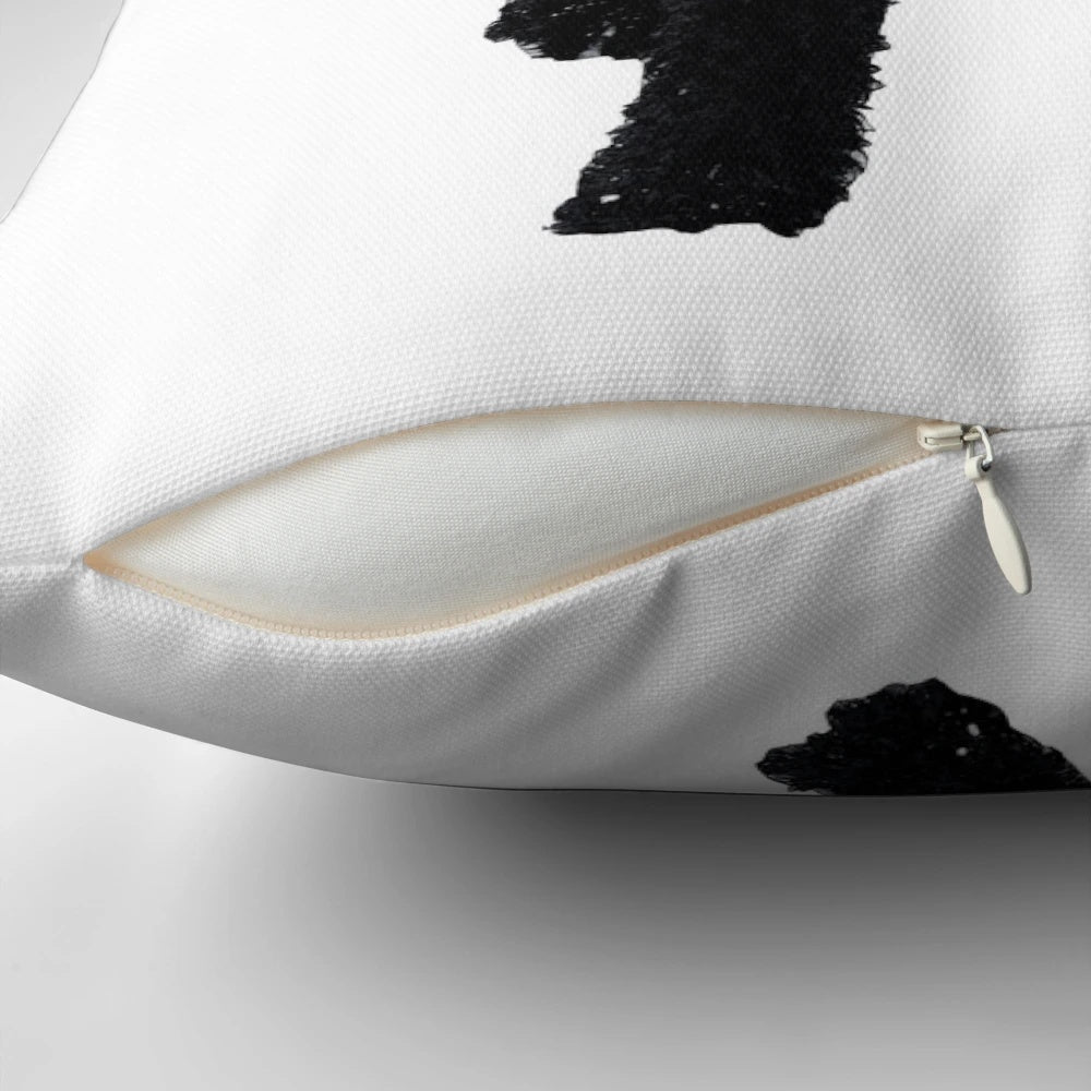 A soft, plush pillow featuring a black goldendoodle dog