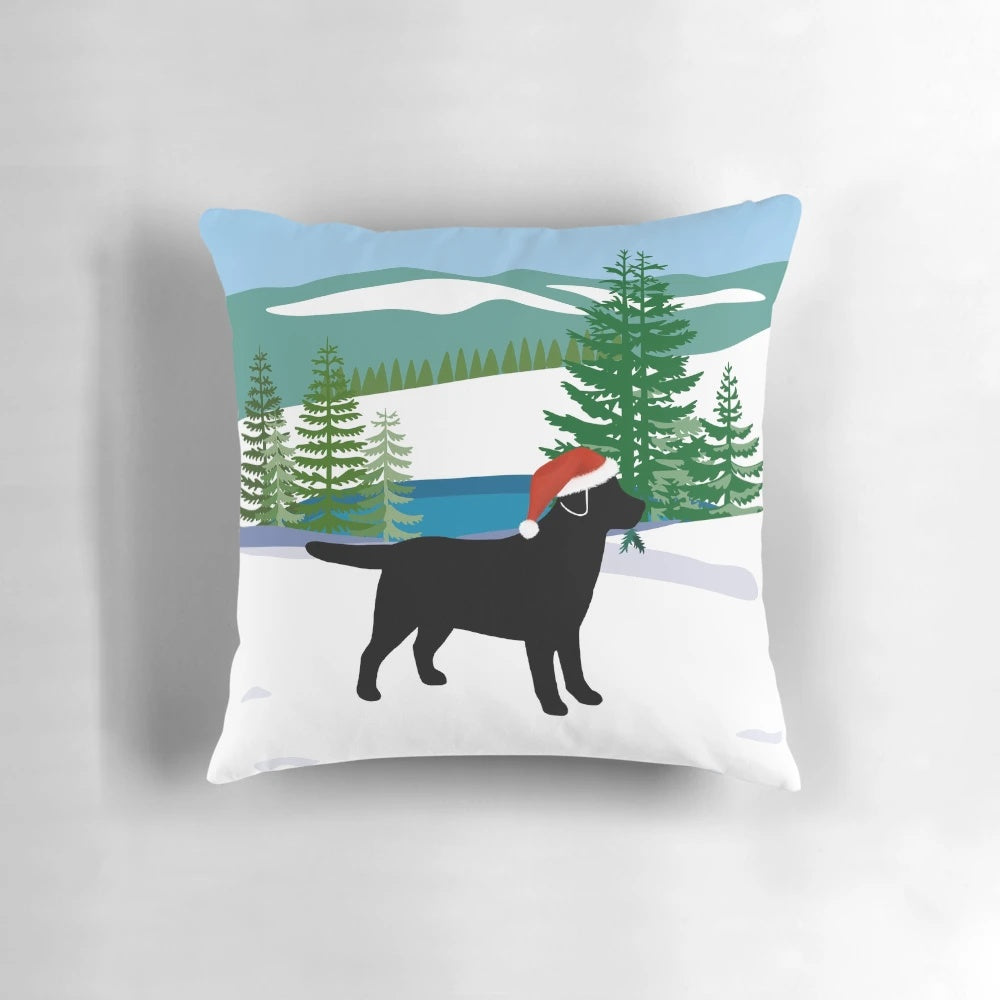 Black Labrador dog in a snowy Christmas scene on a plush pillow