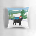 Black Labrador dog in a snowy Christmas scene on a plush pillow
