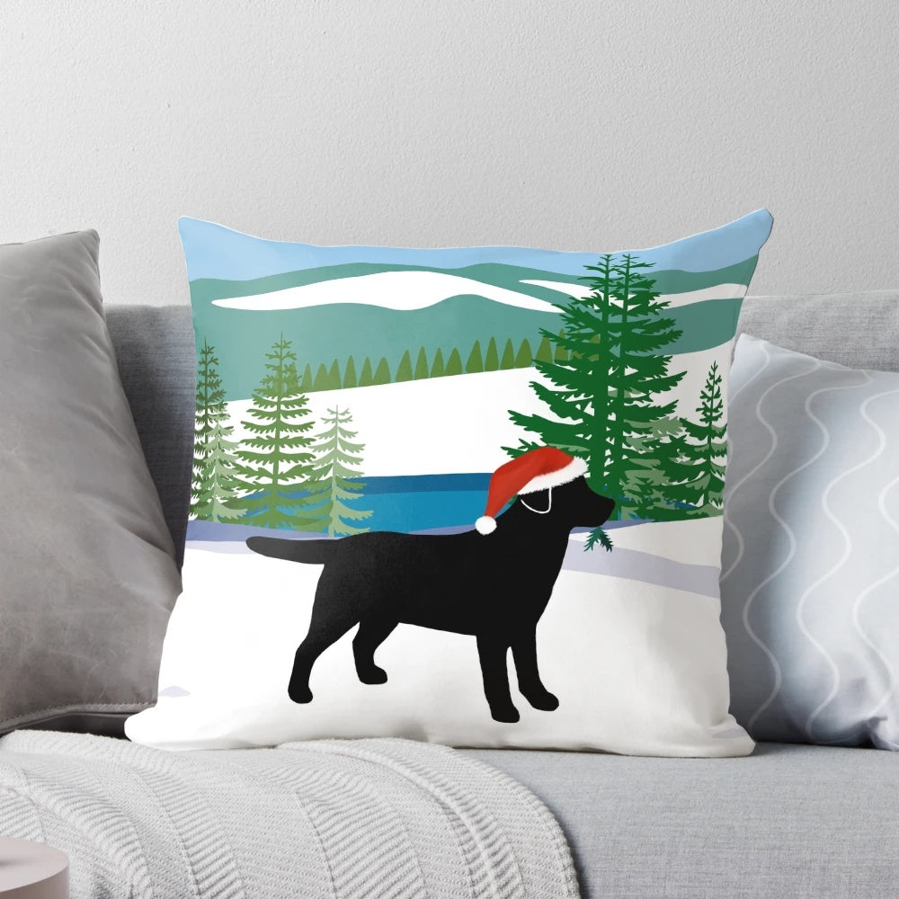 Black Labrador dog in a snowy Christmas scene on a plush pillow