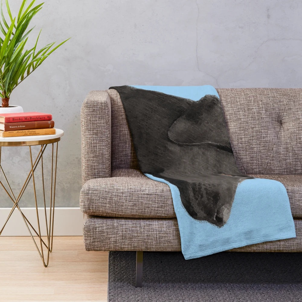 Black Labrador Retriever dog portrait on soft, plush blanket