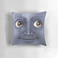 Black moon emoji printed on a decorative throw pillow