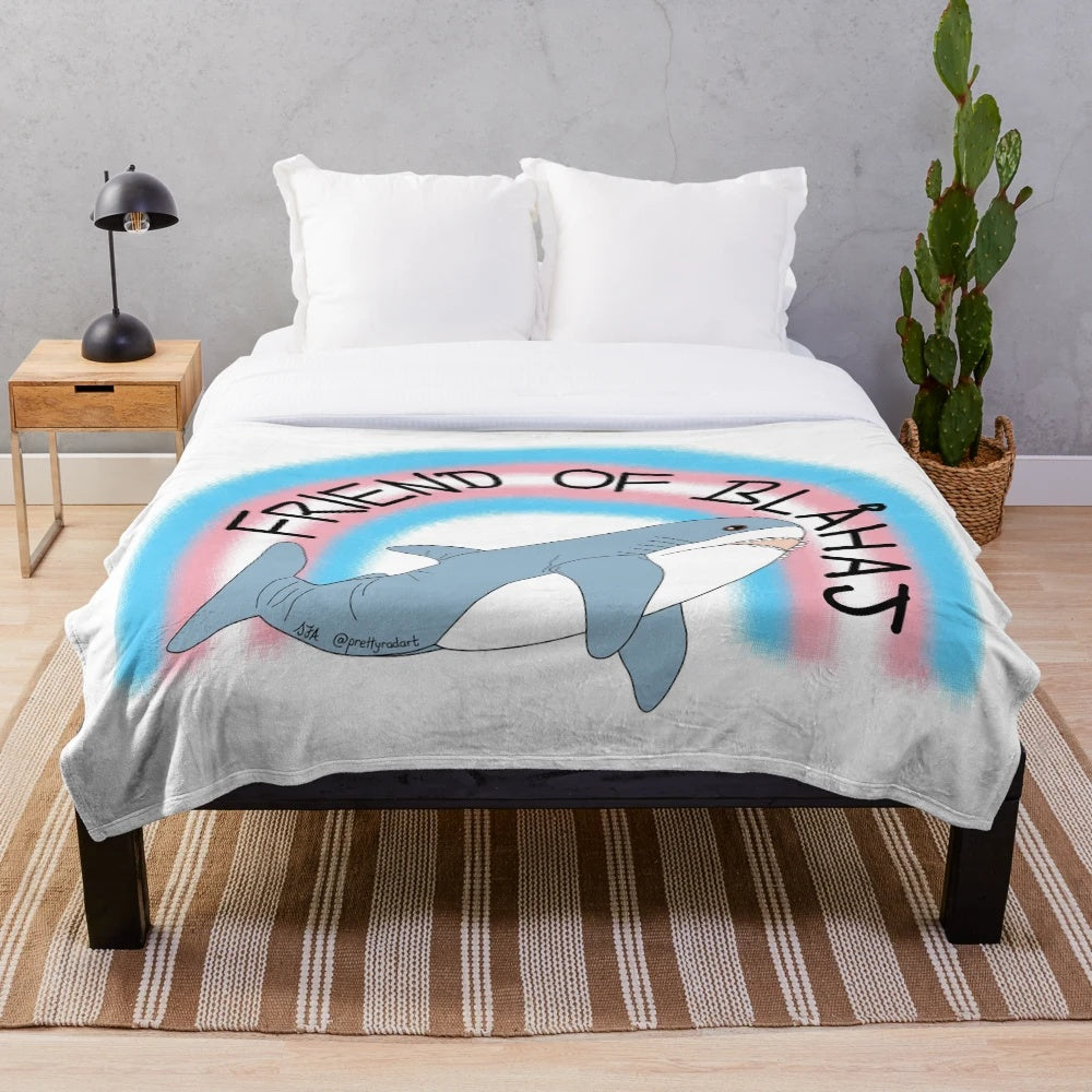 Soft and snuggly plush blanket featuring the iconic IKEA Blahaj shark design in trans pride colors