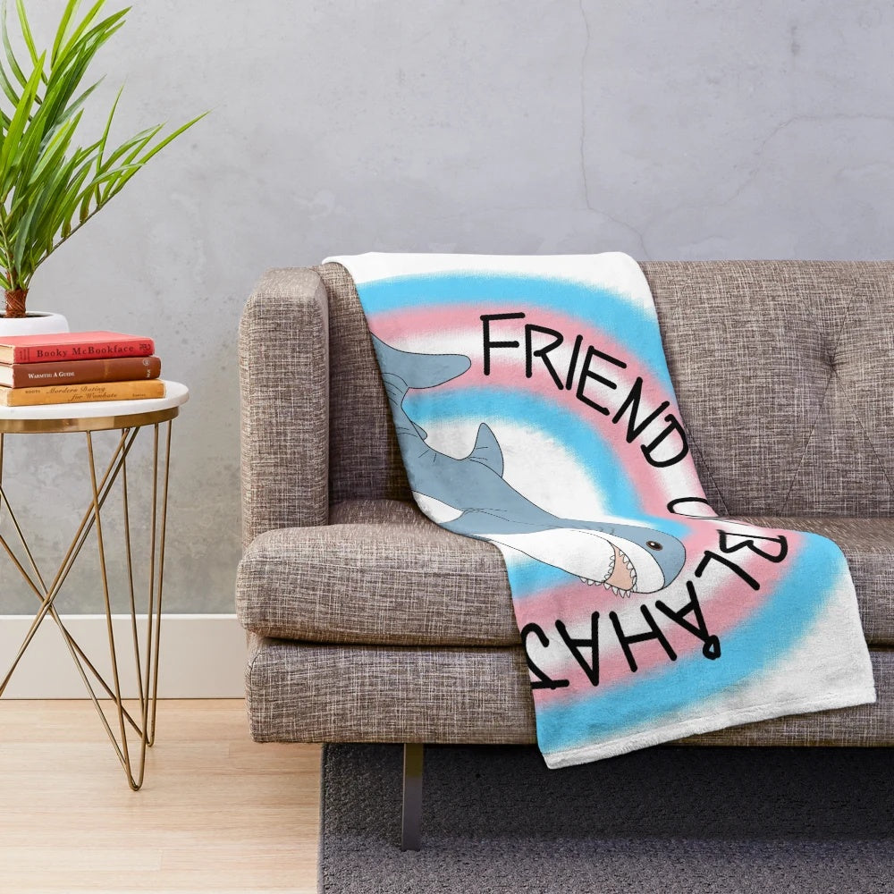 Soft and snuggly plush blanket featuring the iconic IKEA Blahaj shark design in trans pride colors