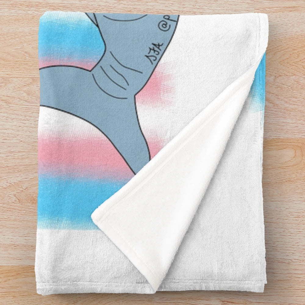 Soft and snuggly plush blanket featuring the iconic IKEA Blahaj shark design in trans pride colors