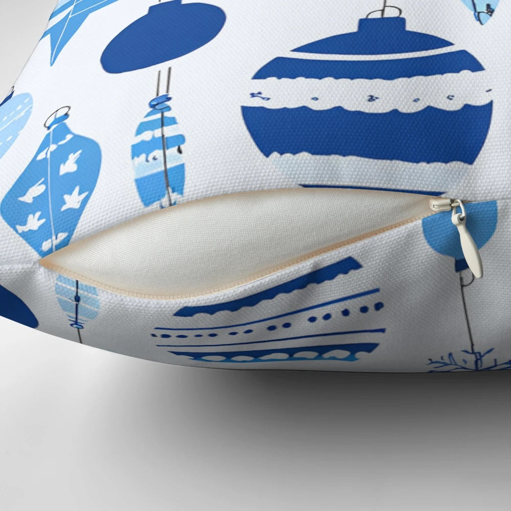 A blue and white patterned Christmas pillow with a festive design, perfect for winter home decoration.