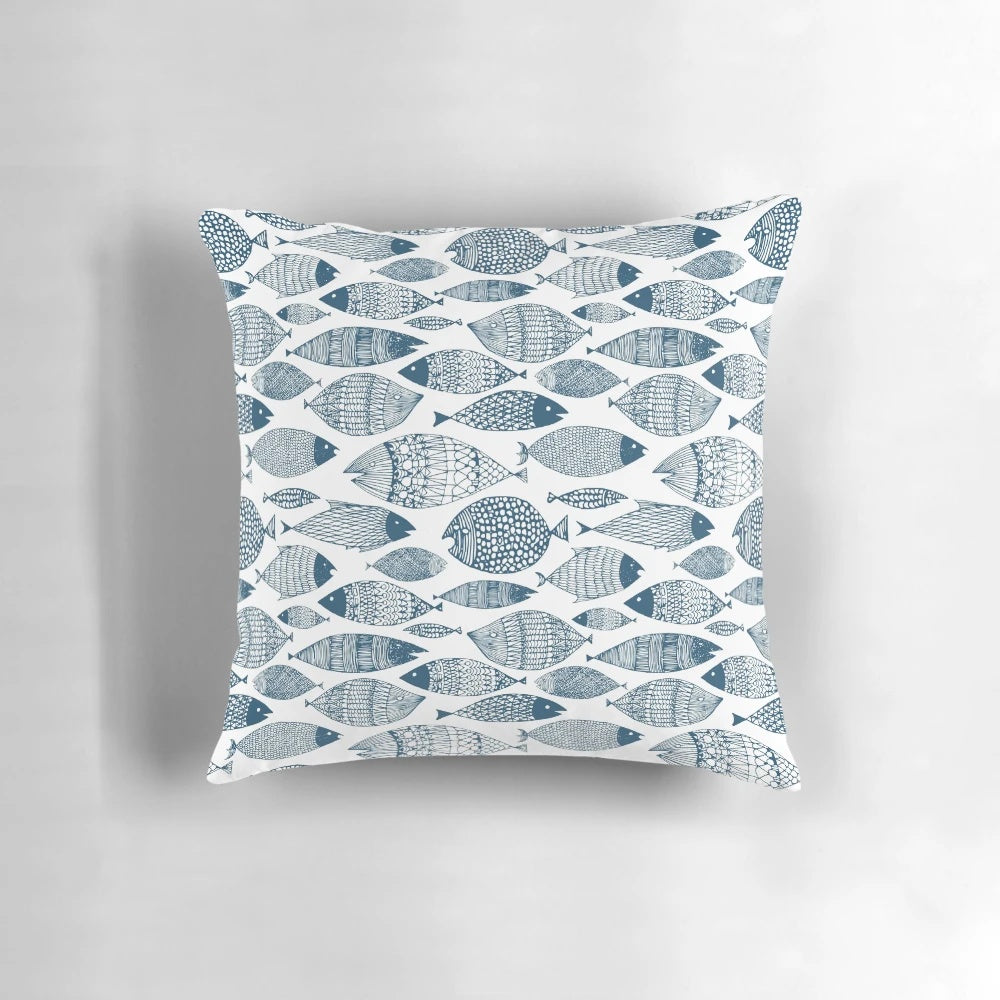 Blue and white fish-patterned pillow, perfect for ocean-inspired Scandinavian home decor.