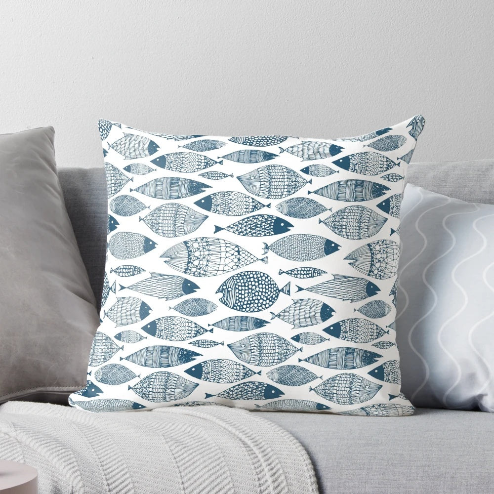 Blue and white fish-patterned pillow, perfect for ocean-inspired Scandinavian home decor.