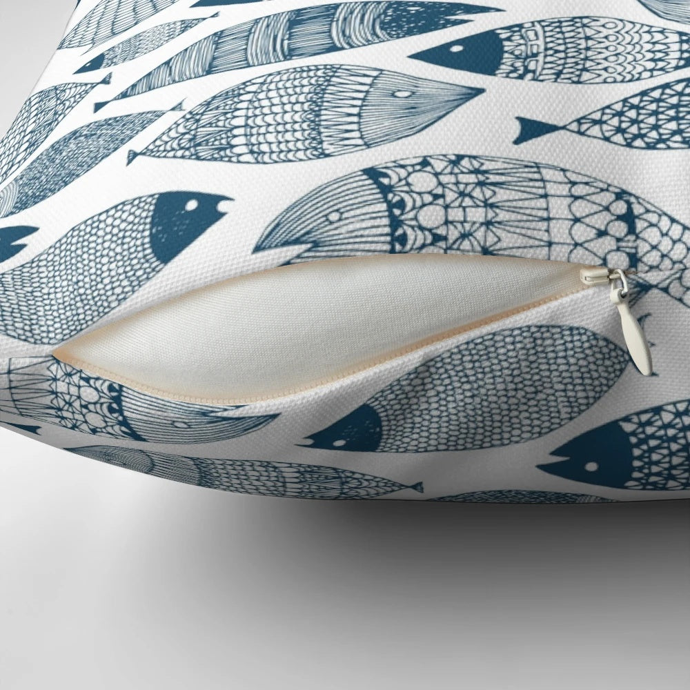 Blue and white fish-patterned pillow, perfect for ocean-inspired Scandinavian home decor.