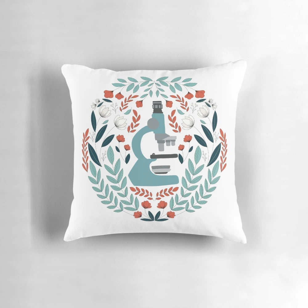 Blue and white folk-style pillow with a microscope design, perfect for science lovers.