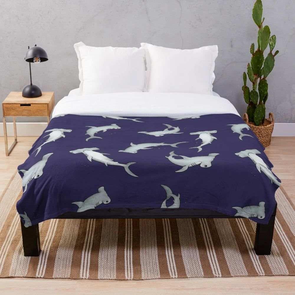 Blue plush blanket with a hammerhead shark design