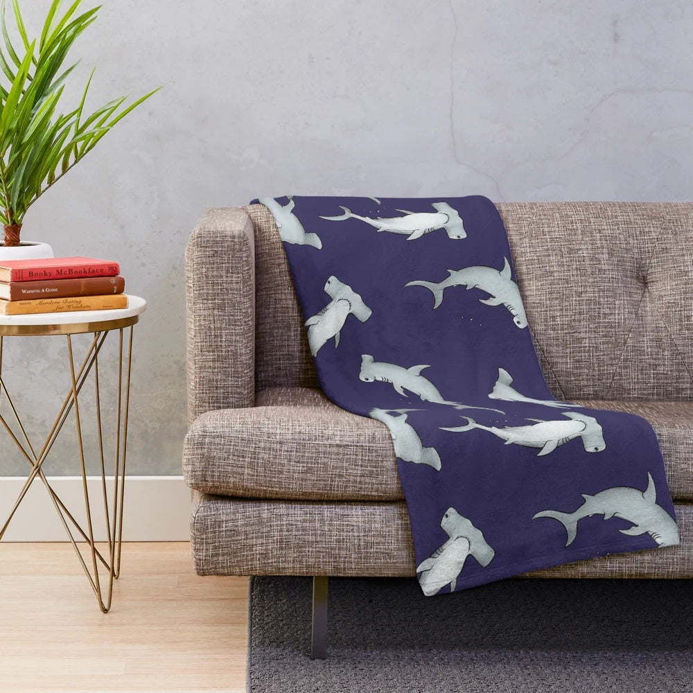 Blue plush blanket with a hammerhead shark design