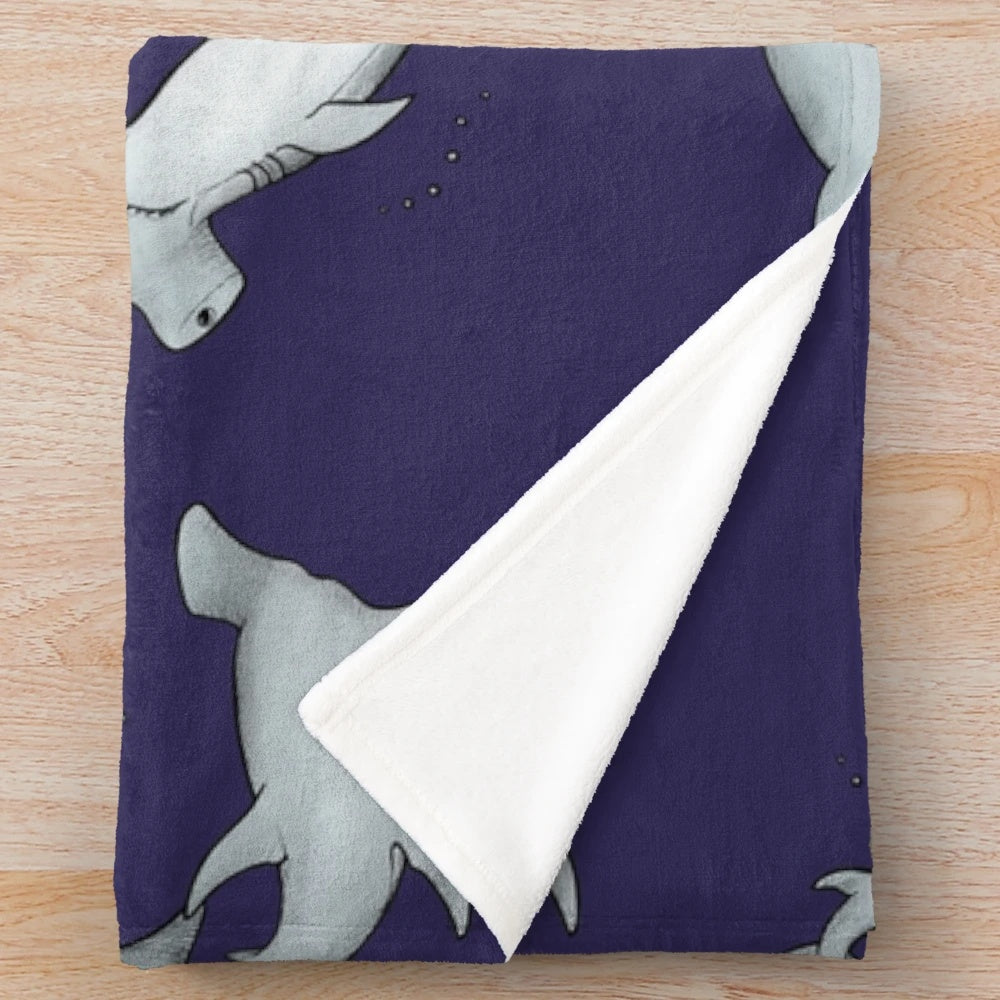 Blue plush blanket with a hammerhead shark design