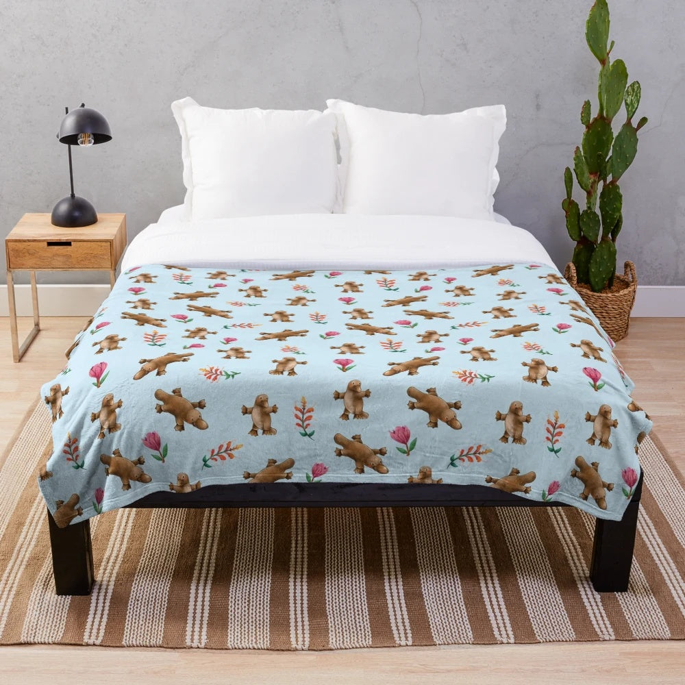 Blue plush blanket with Australian platypus and leaf pattern design