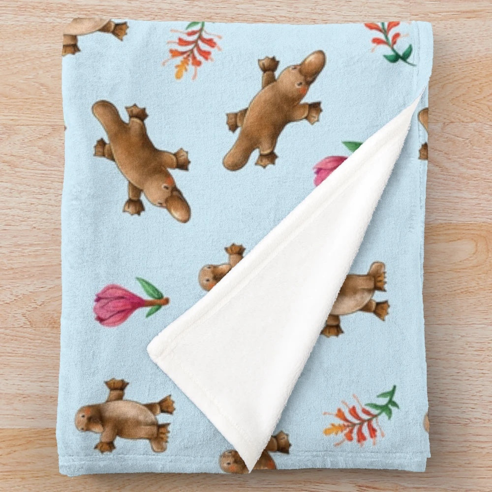 Blue plush blanket with Australian platypus and leaf pattern design