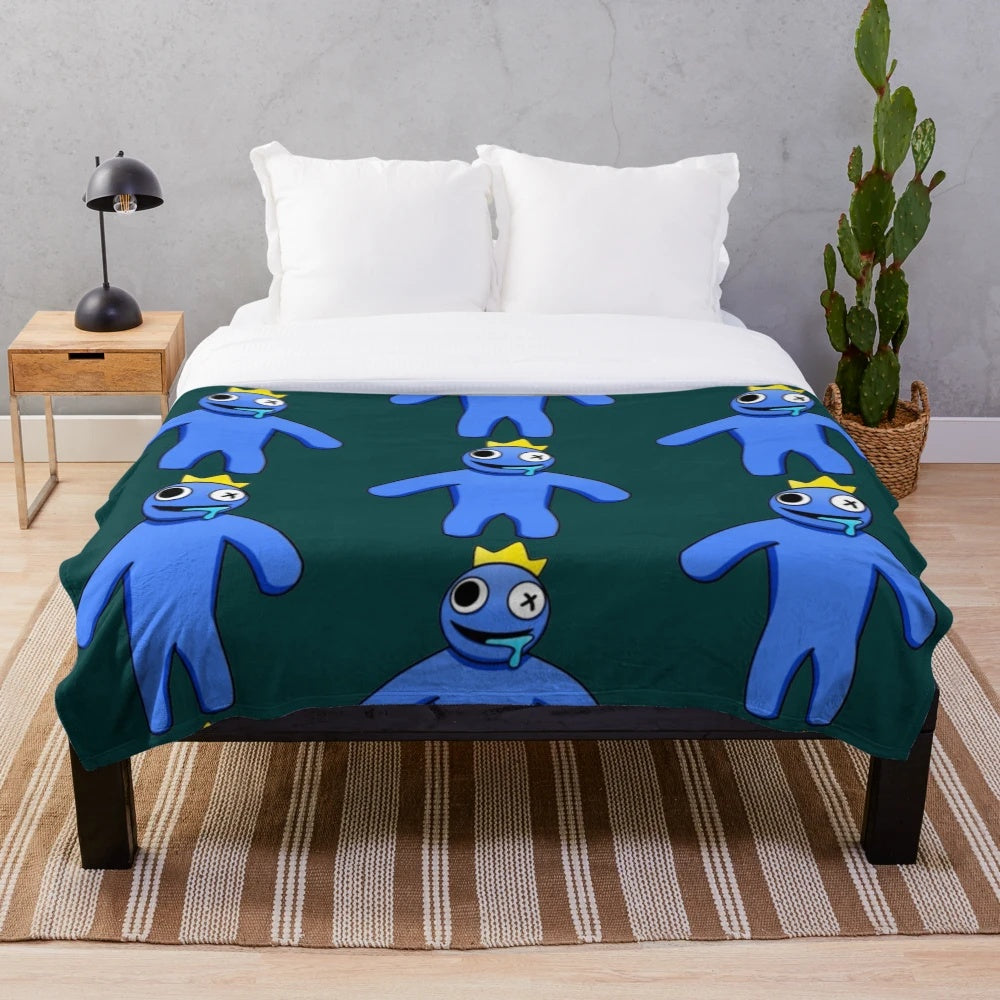 A soft, blue plush blanket with a rainbow design, perfect for Roblox fans.