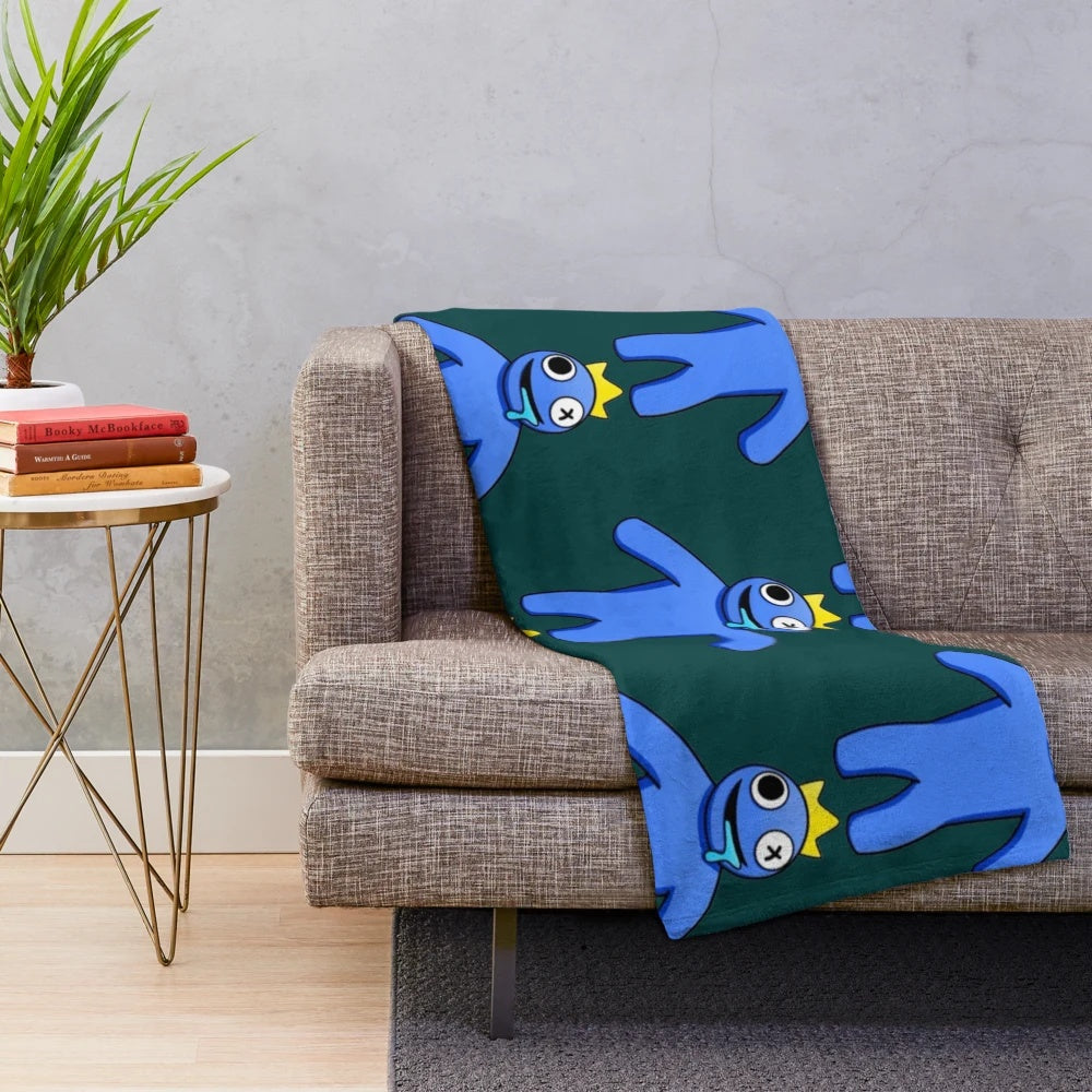 A soft, blue plush blanket with a rainbow design, perfect for Roblox fans.