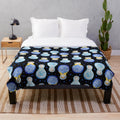 Blue plush blanket with watercolor floral and nesting doll pattern