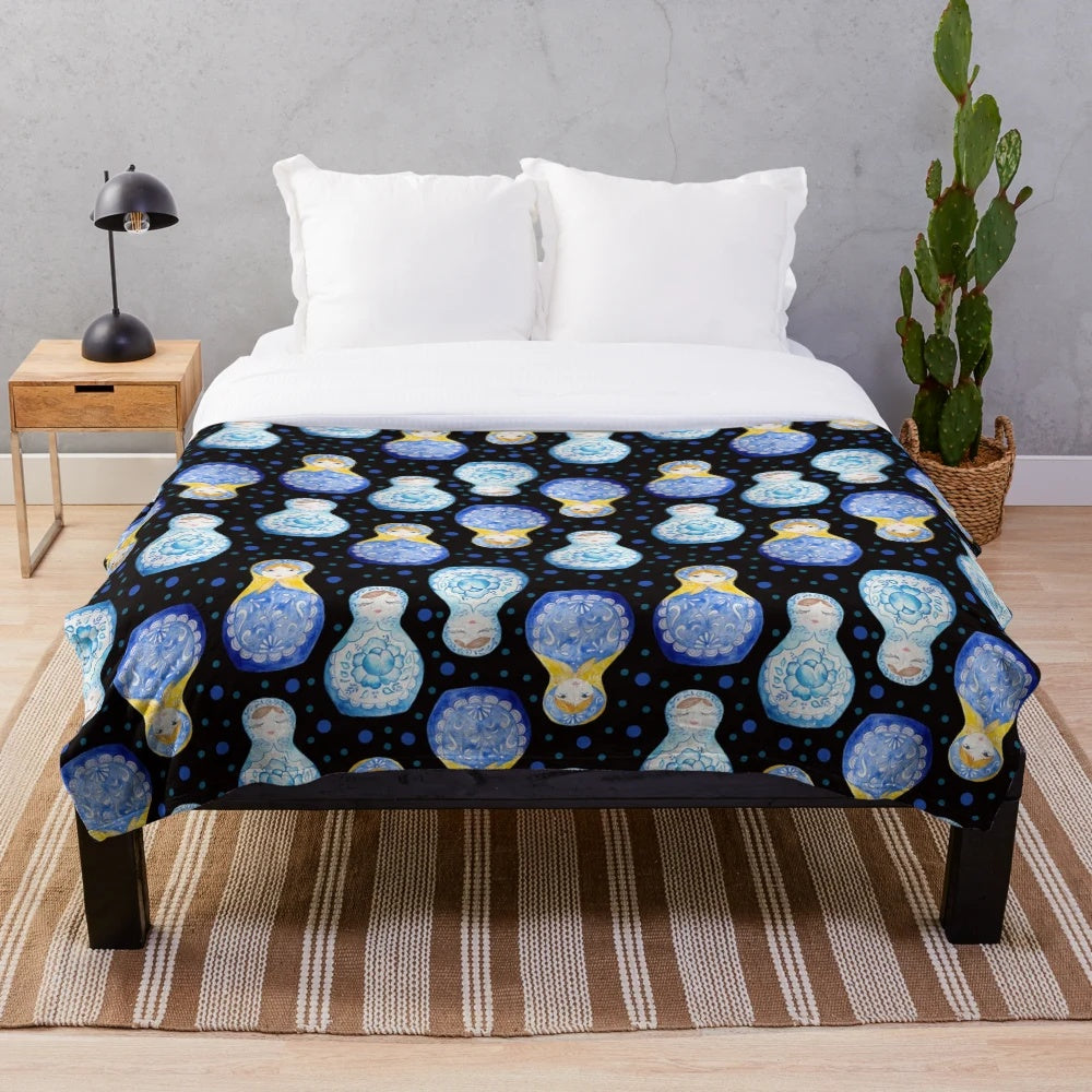 Blue plush blanket with watercolor floral and nesting doll pattern