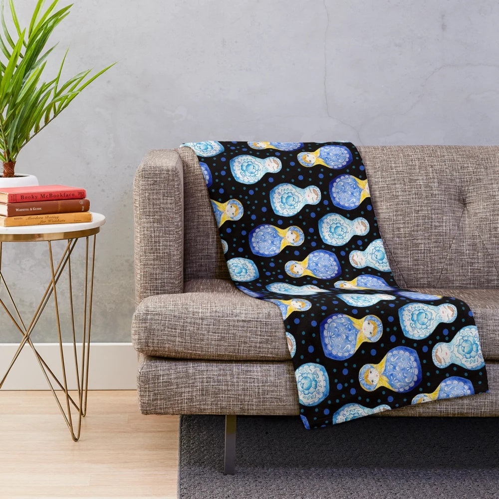 Blue plush blanket with watercolor floral and nesting doll pattern