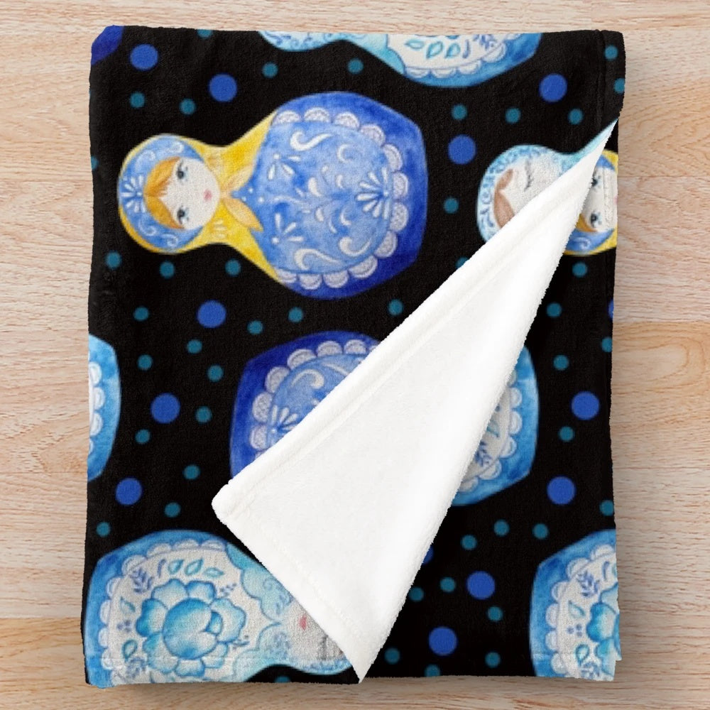 Blue plush blanket with watercolor floral and nesting doll pattern