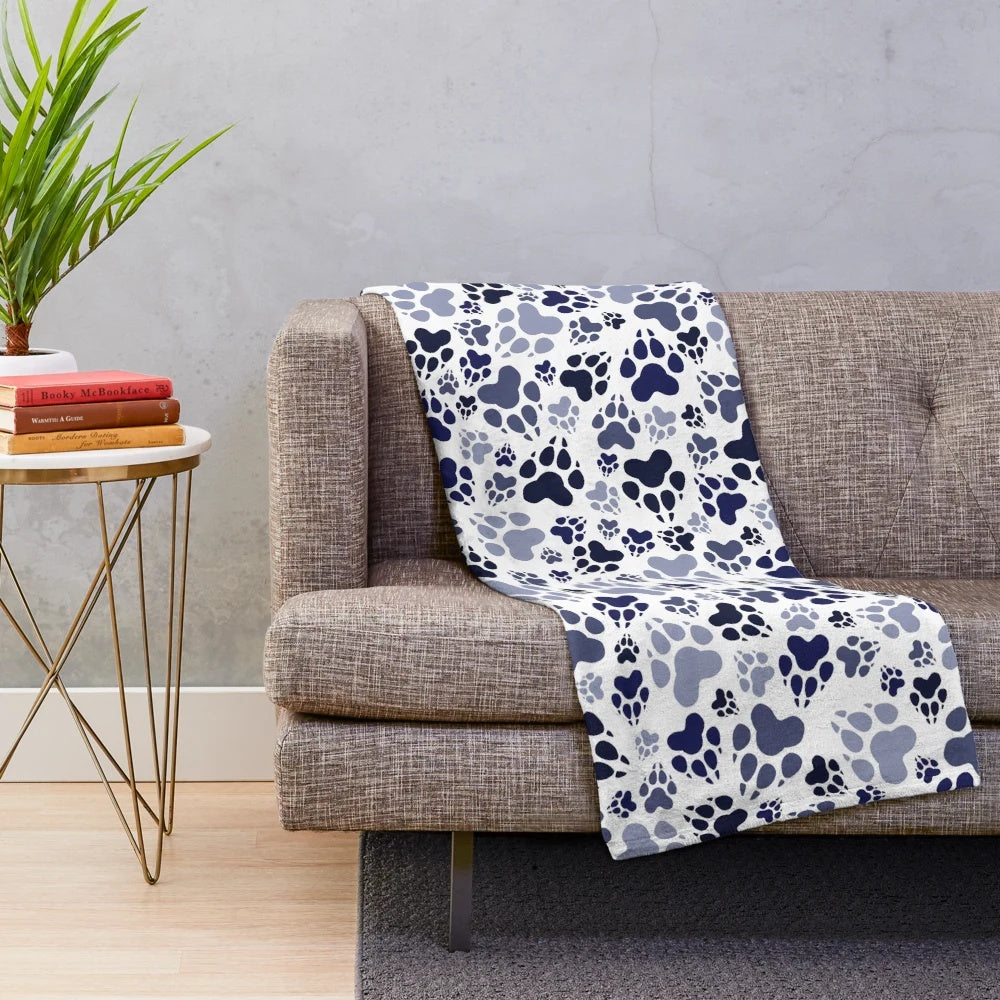 Blue plush dog blanket with paw print design