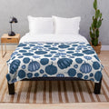 Blue pumpkin pattern on a plush white blanket