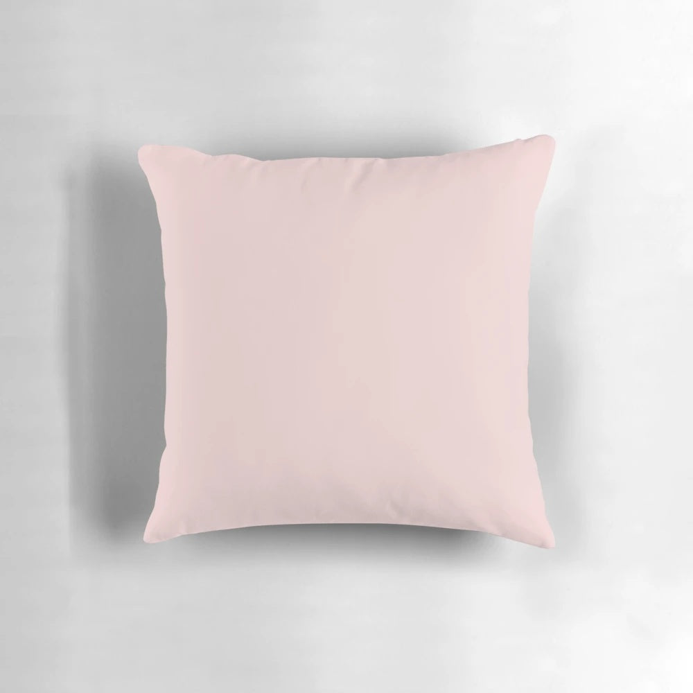 Soft and stylish blush pink solid pillow for a relaxing home decor accent.