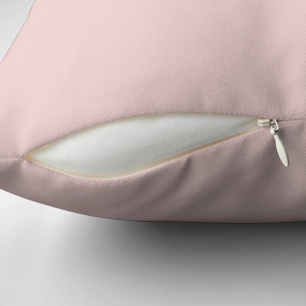 Soft and stylish blush pink solid pillow for a relaxing home decor accent.