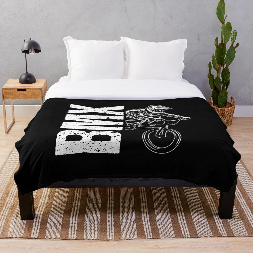 Plush blanket featuring a BMX-inspired design for cycling enthusiasts