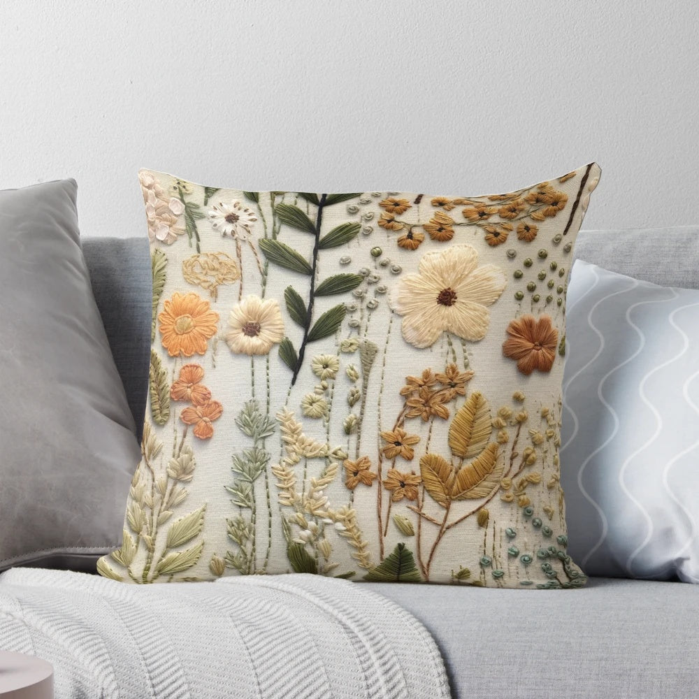Boho-inspired faux embroidered pillow featuring muted color wildflowers in an autumn palette.