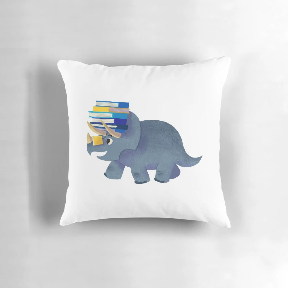 Soft, plush pillow featuring a cute dinosaur design, perfect for reading and bedroom decor.