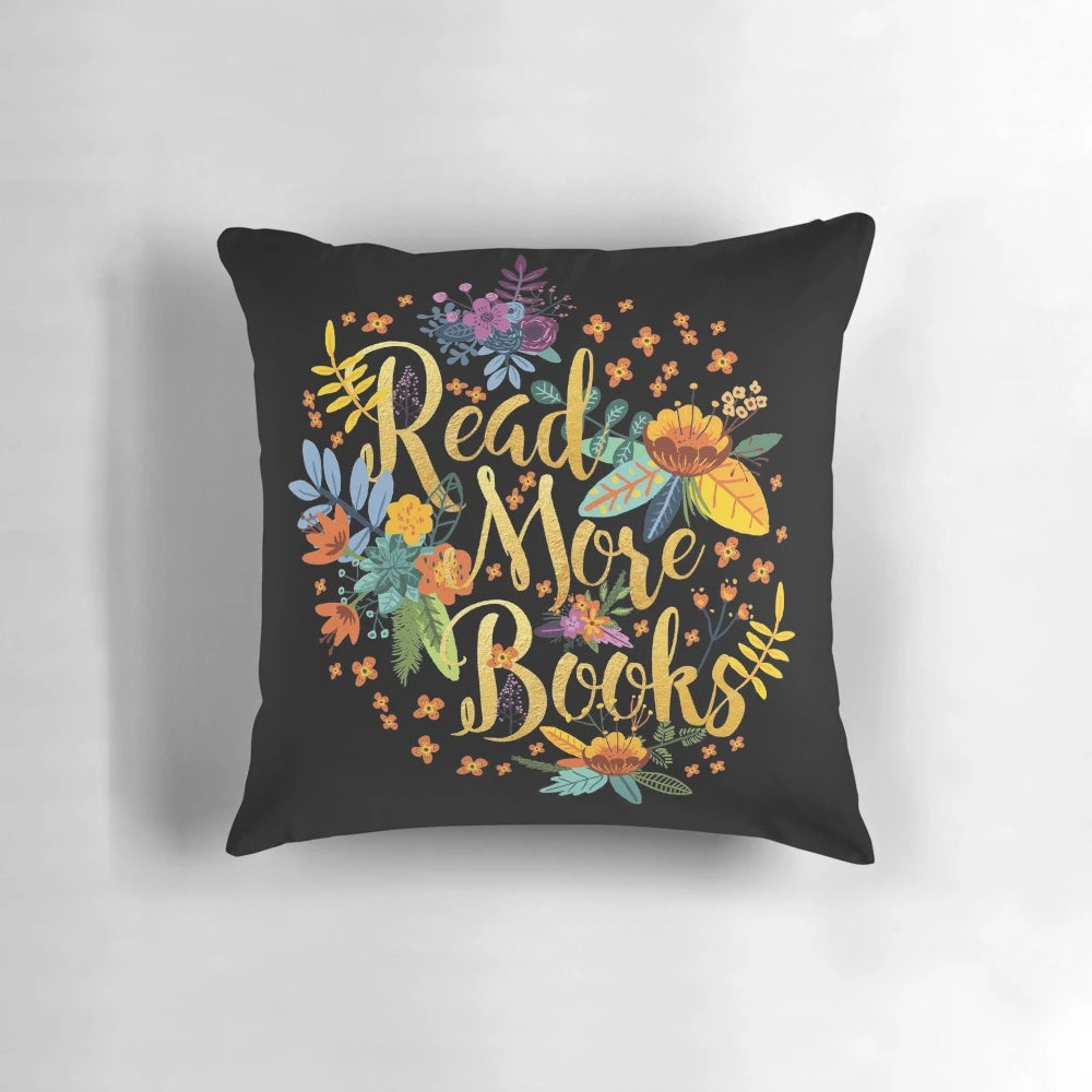 Decorative black pillow with floral gold foil design, perfect for book lovers