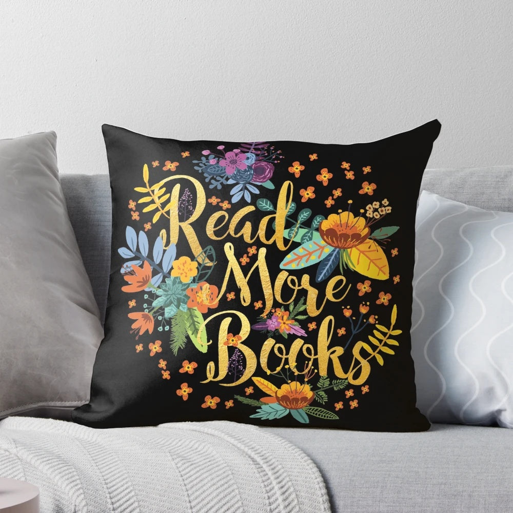 Decorative black pillow with floral gold foil design, perfect for book lovers
