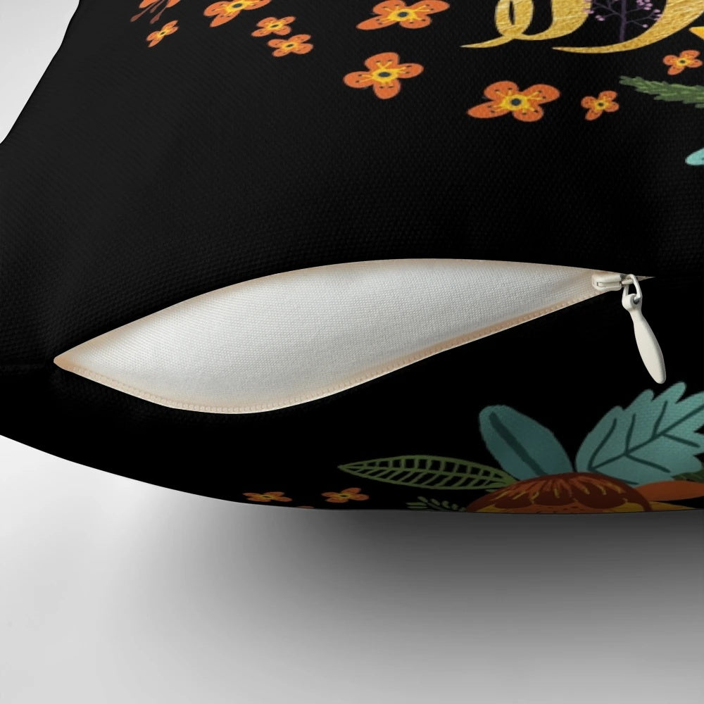 Decorative black pillow with floral gold foil design, perfect for book lovers