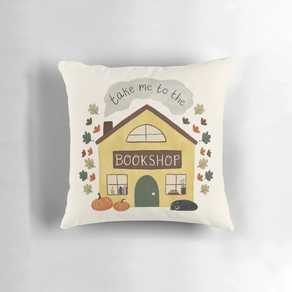 Cozy pumpkin and black cat decorative pillow for book lovers
