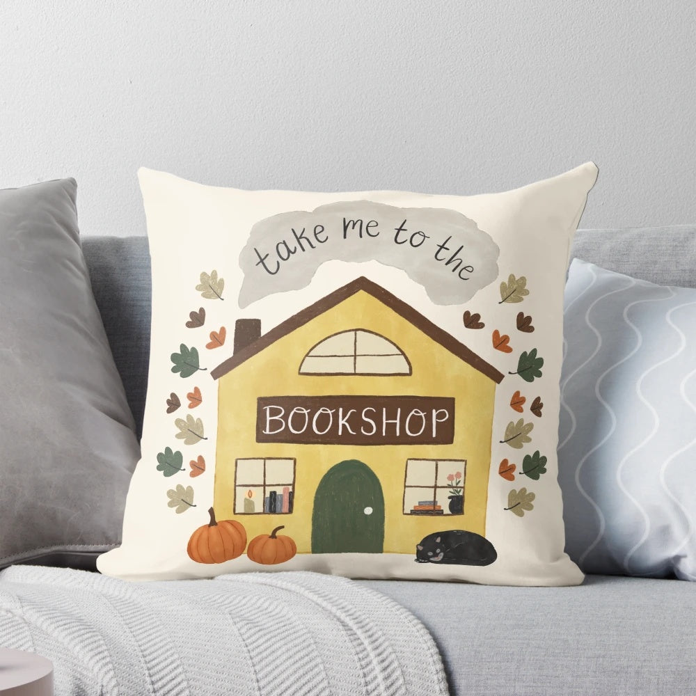 Cozy pumpkin and black cat decorative pillow for book lovers