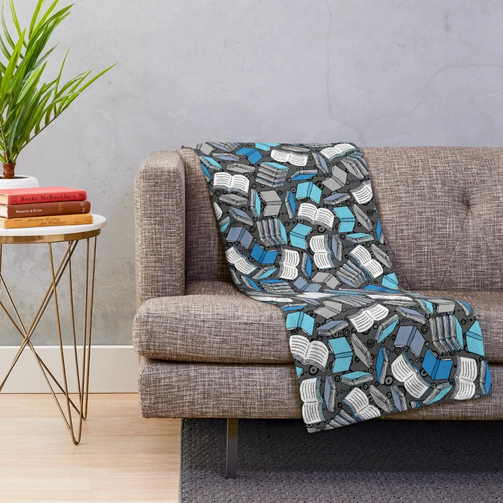 Plush blanket with a sketch-style book and reading-themed pattern
