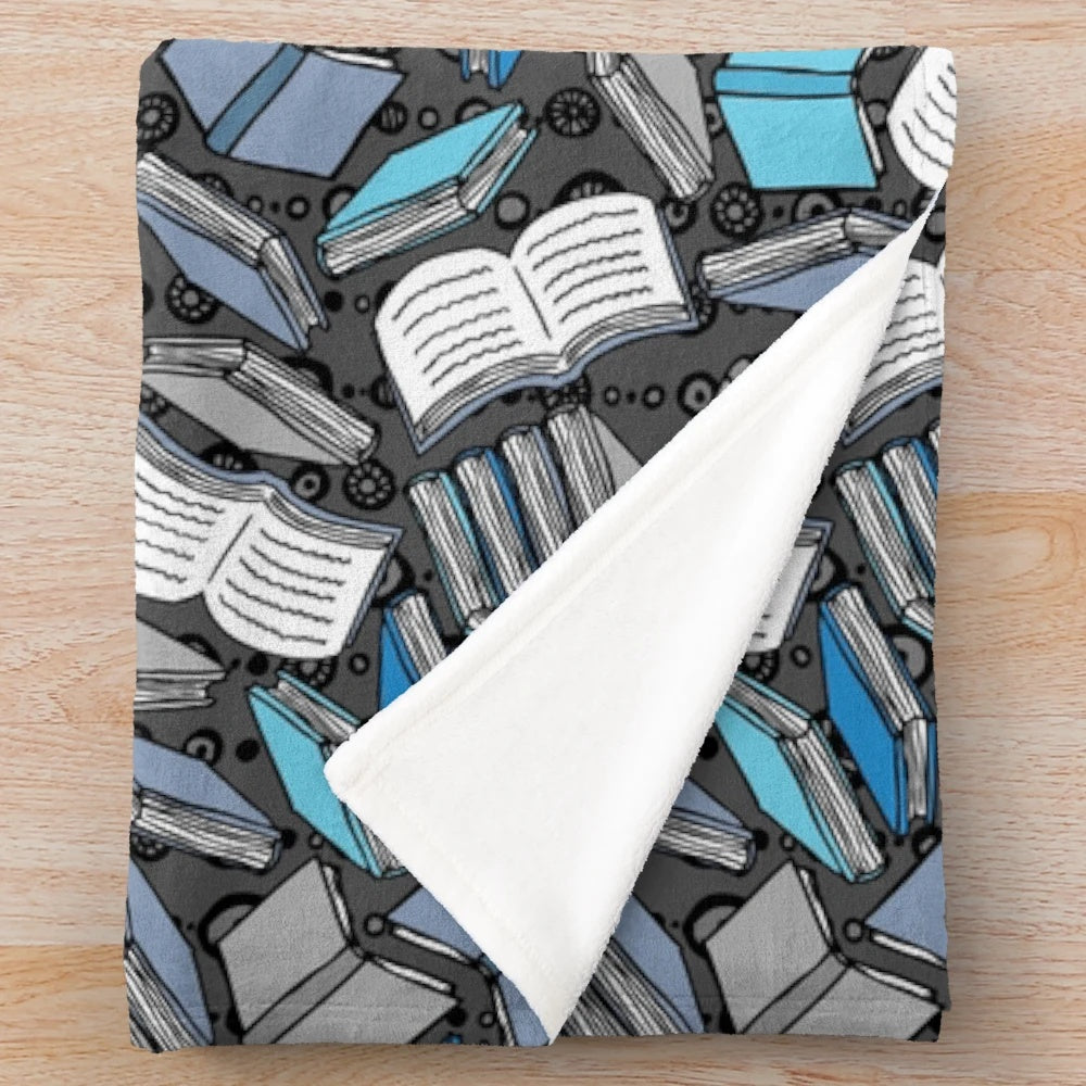Plush blanket with a sketch-style book and reading-themed pattern
