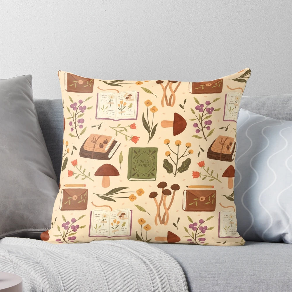 Decorative forest-themed throw pillow with illustrated mushrooms, flowers, and books