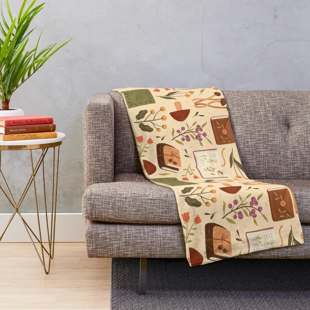 Plush blanket with a bookish forest and botanical pattern