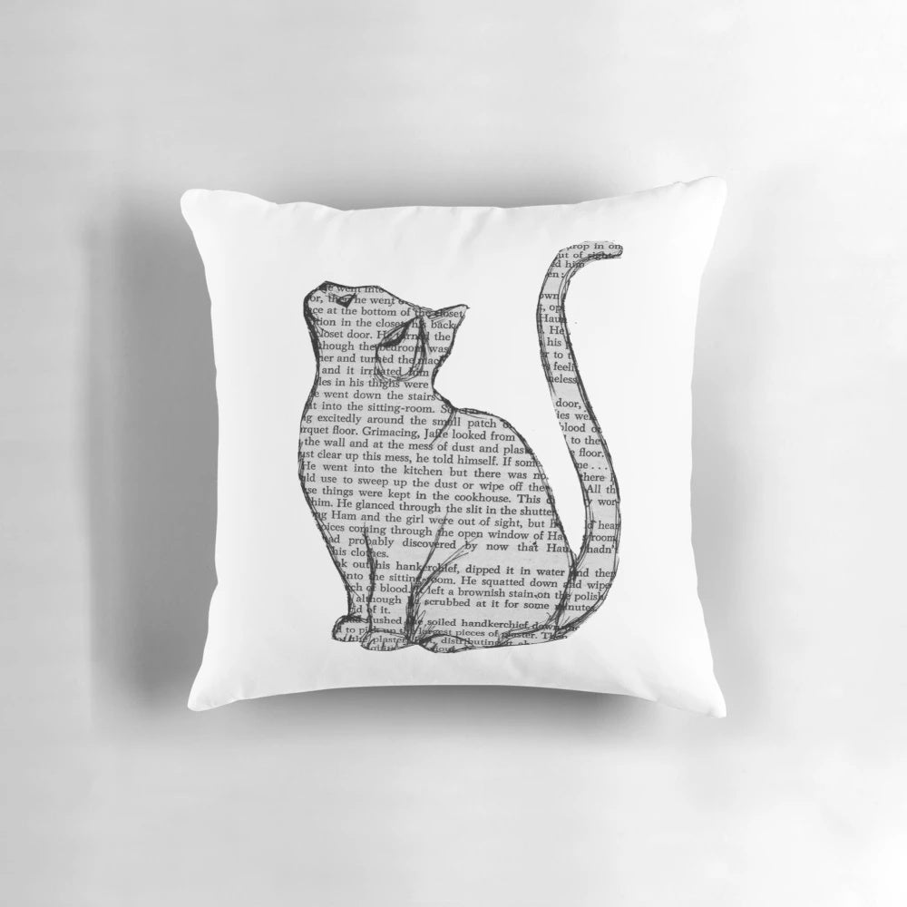 A plush pillow featuring a playful design with books and cats, perfect for book lovers and pet owners.