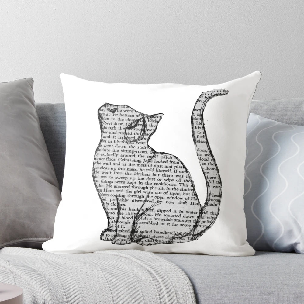 A plush pillow featuring a playful design with books and cats, perfect for book lovers and pet owners.