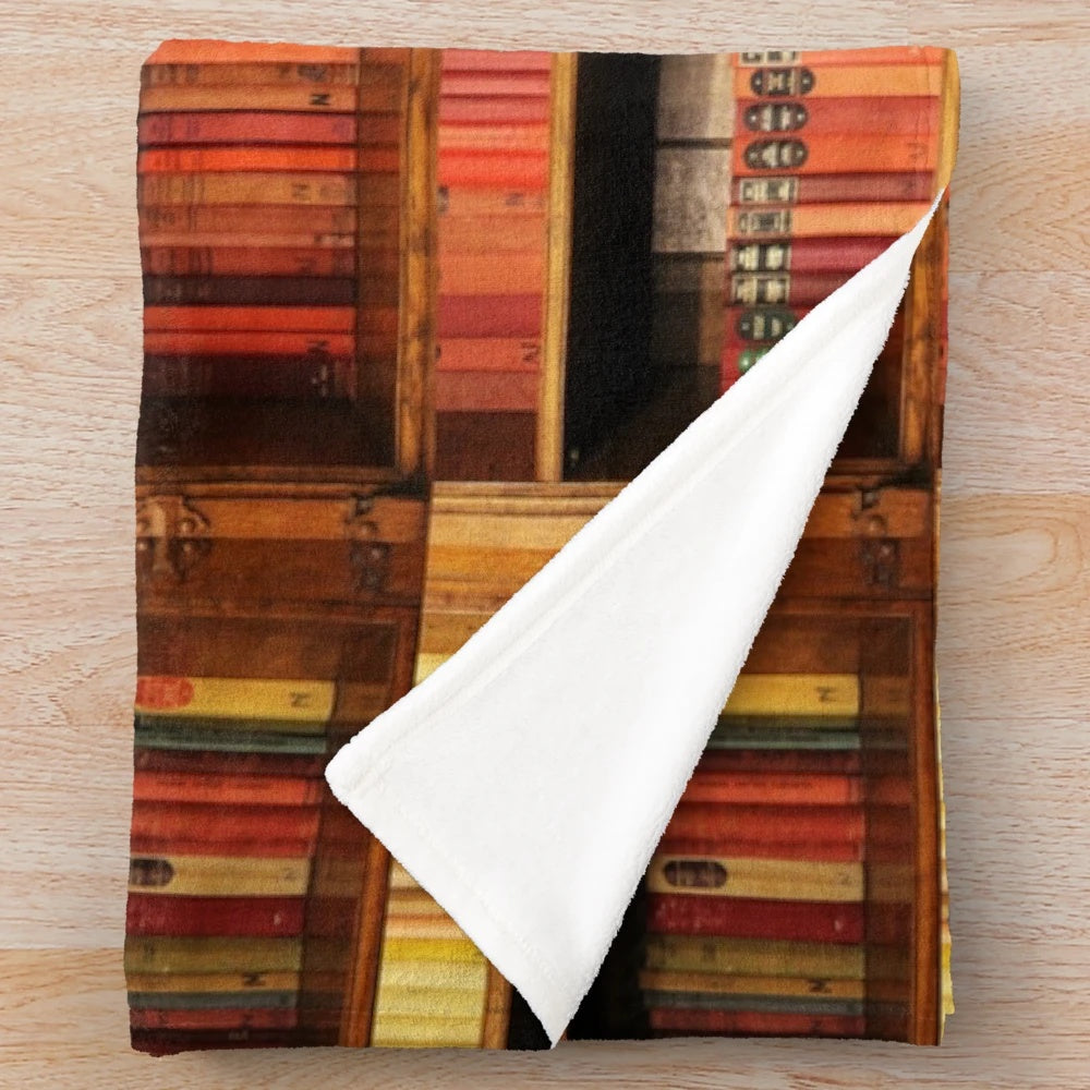 Plush blanket with a bookshelf design for book lovers