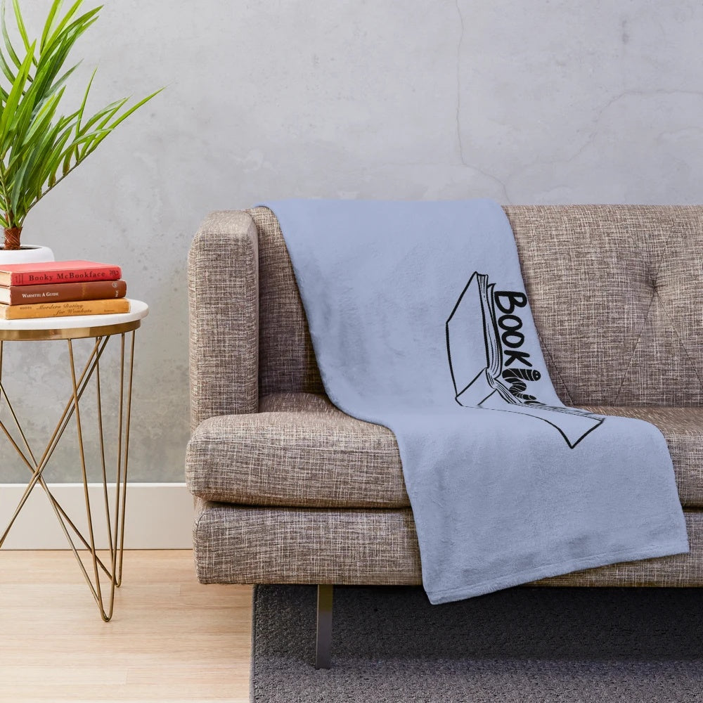 Cozy plush blanket featuring a bookworm design for book lovers
