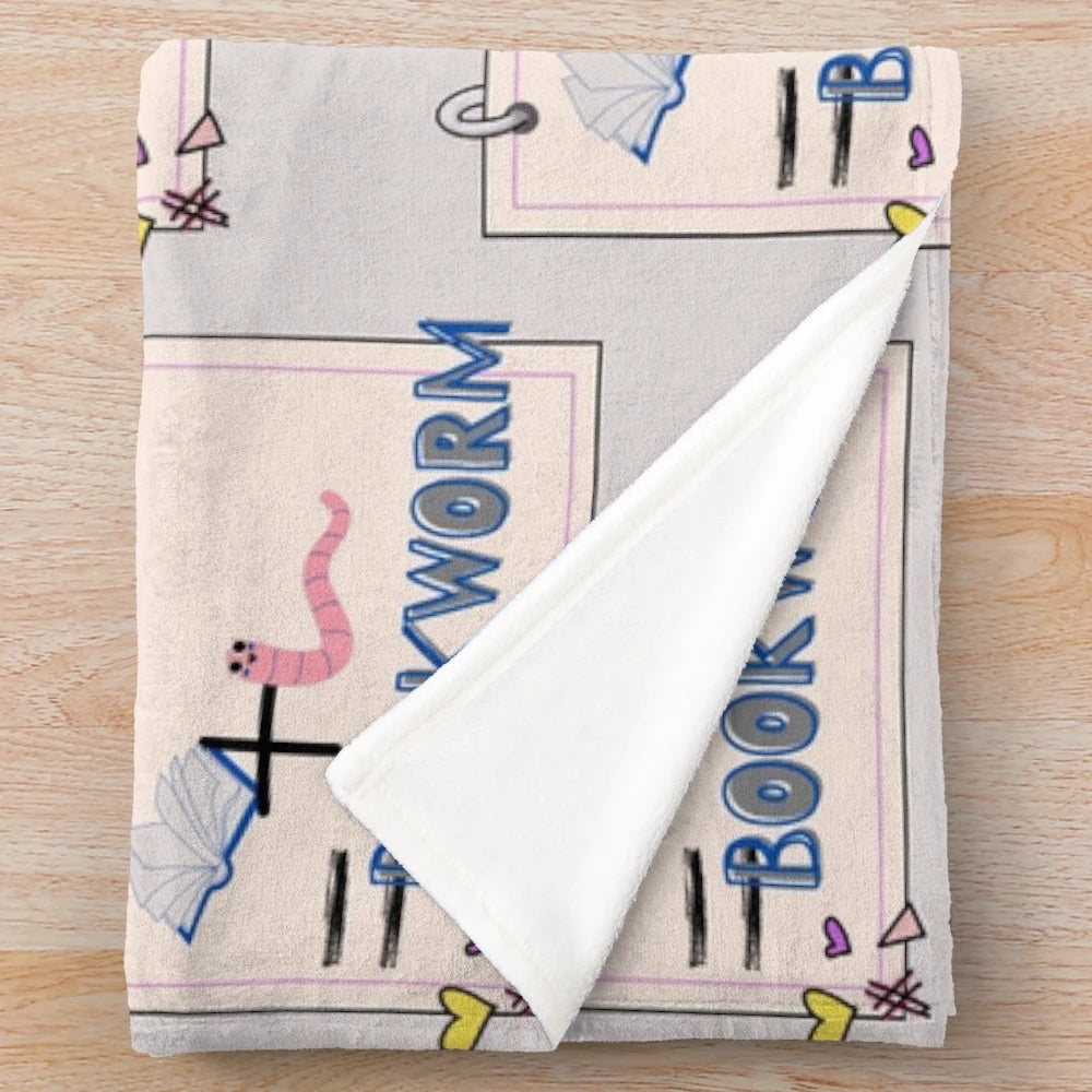 Soft and snuggly plush blanket with a whimsical bookworm design, perfect for book lovers and reading enthusiasts.