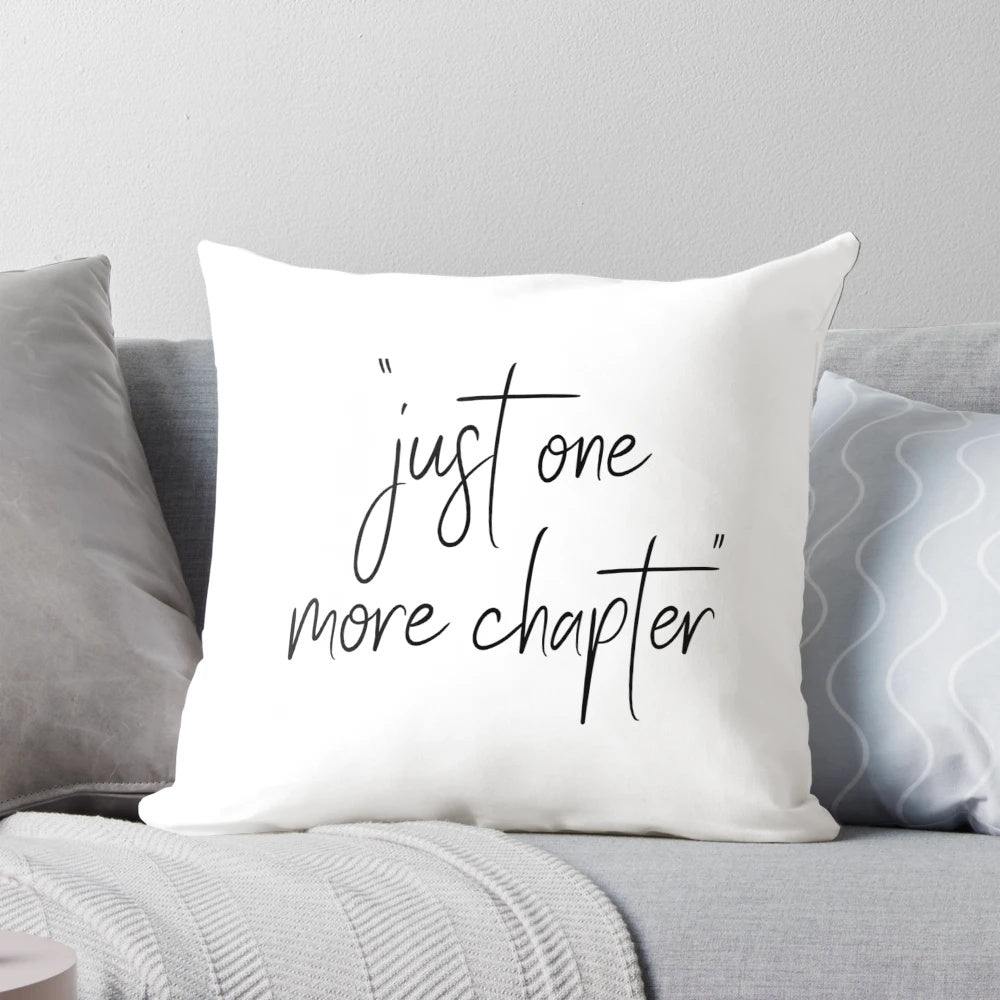 A decorative throw pillow with the text "Just One More Chapter" in a whimsical, hand-lettered style, perfect for book lovers and reading enthusiasts.