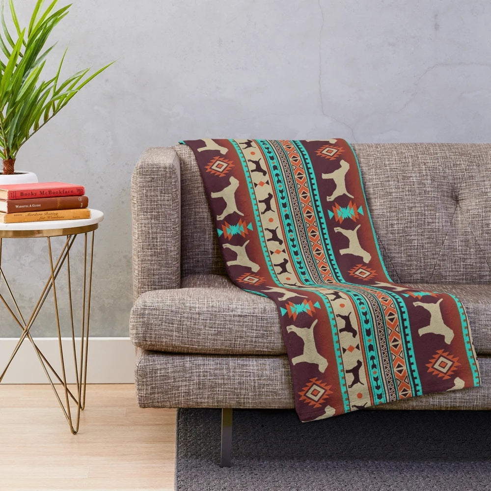 Border Terrier dog breed on a plush boho-style blanket with sunset colors